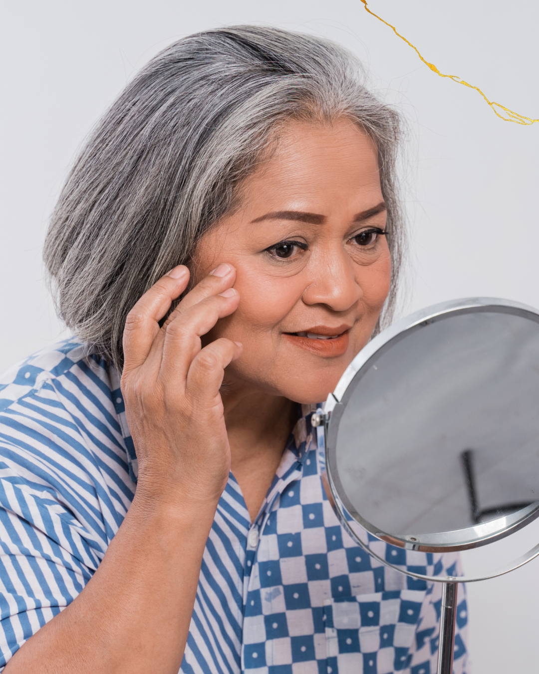 a person examines their face in a mirror.