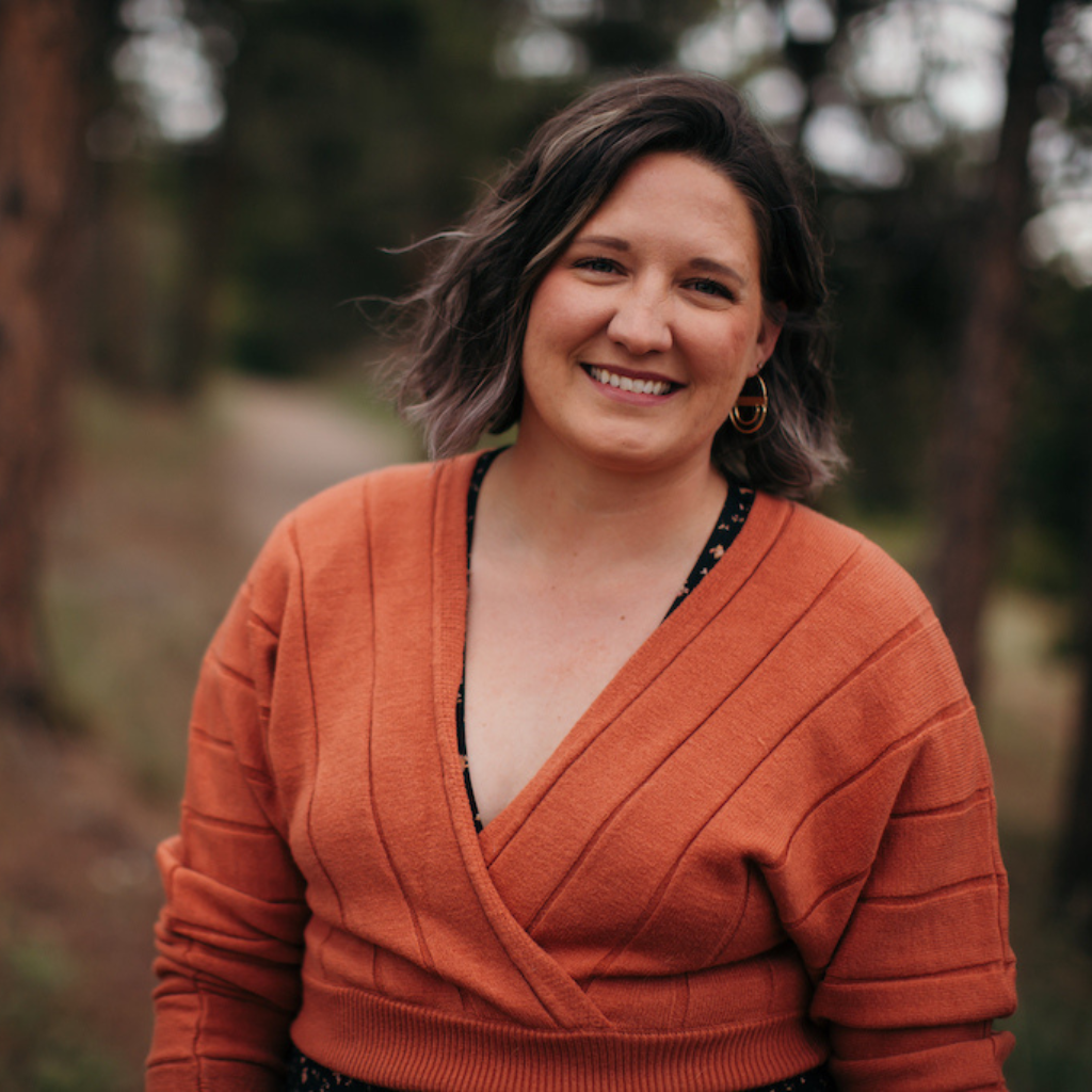 post author tessa mcswain. She is standing outside in an orange sweater.
