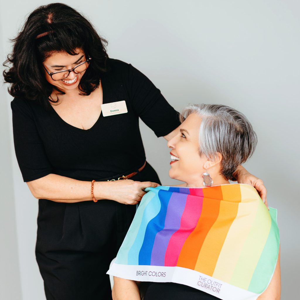 Donna drapes Dr. Menezes with color fabric.